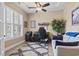 Comfortable home office with neutral walls, wood floor, plantation shutters, and ceiling fan at 14 Cobblestone Dr., Pawleys Island, SC 29585