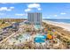 An aerial view of the building highlighting the many pool, water park, and beach amenities at 141 Hartland Dr. # 5-C, Myrtle Beach, SC 29572