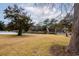 Beautiful backyard and lake view with green grass, large trees and a walking bridge at 141 Hartland Dr. # 5-C, Myrtle Beach, SC 29572