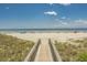 Scenic beach access via a wooden boardwalk, leading to a sandy beach and ocean views at 141 Hartland Dr. # 5-C, Myrtle Beach, SC 29572
