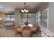 Cozy dining area featuring wicker chairs, a glass table, and nature views at 141 Hartland Dr. # 5-C, Myrtle Beach, SC 29572