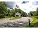 Community entry gate with security booth, showcasing an American flag and landscaped surroundings at 141 Hartland Dr. # 5-C, Myrtle Beach, SC 29572