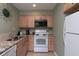 Well-equipped kitchen features wood cabinets and matching appliances at 141 Hartland Dr. # 5-C, Myrtle Beach, SC 29572