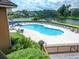 An outdoor pool and lounge chairs highlight this pool alongside a calm body of water at 141 Hartland Dr. # 5-C, Myrtle Beach, SC 29572