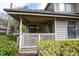 Charming covered front porch with wooden railing, privacy bushes and a manicured lawn at 141 Hartland Dr. # 5-C, Myrtle Beach, SC 29572