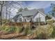 The backyard view of white house featuring a wooden deck and patio seating at 1427 Mcmaster Dr., Myrtle Beach, SC 29575