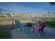 Cozy backyard patio with a fire pit, chairs and lovely view of the pond and community at 148 Splendor Circle, Murrells Inlet, SC 29576