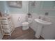 Powder room with a pedestal sink, wainscotting, and wood-look flooring at 148 Splendor Circle, Murrells Inlet, SC 29576