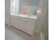 Bright bathroom with double vanity, white cabinets, tiled floors and walls, and a glass shower enclosure at 148 Splendor Circle, Murrells Inlet, SC 29576