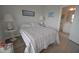 Cozy bedroom featuring a striped bedspread, and an adjacent ensuite bathroom at 148 Splendor Circle, Murrells Inlet, SC 29576