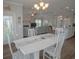 Bright dining area with modern white table and chairs adjacent to a living room with a fireplace and large tv at 148 Splendor Circle, Murrells Inlet, SC 29576