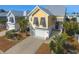 Beautiful two-story home featuring a lovely yard, spacious garage, and charming entryway with palm trees at 148 Splendor Circle, Murrells Inlet, SC 29576