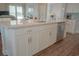 Close-up view of a kitchen island featuring white cabinets, stainless steel appliances, and a quartz countertop at 148 Splendor Circle, Murrells Inlet, SC 29576