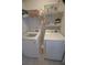 Efficient laundry room with modern washer and dryer units and ample shelving for storage and organization at 148 Splendor Circle, Murrells Inlet, SC 29576