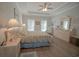 Inviting main bedroom features tray ceilings, bright windows, floral bedding, and a comfortable seating area at 148 Splendor Circle, Murrells Inlet, SC 29576