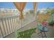 Relaxing porch with views of a community lake and fountain, featuring comfortable seating and decorative curtains at 148 Splendor Circle, Murrells Inlet, SC 29576