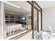 Spacious balcony with clear glass barrier overlooking the living space and comfortable seating at 1501 S Ocean Blvd. # 706, Myrtle Beach, SC 29577