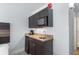 Compact kitchenette equipped with granite counters, a microwave, sink and dark cabinets at 1501 S Ocean Blvd. # 706, Myrtle Beach, SC 29577