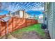 Fenced backyard with green grass and a satellite dish at 1551 Victoria Ln., Myrtle Beach, SC 29577