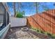 Private backyard with a fire pit, wooden fence, and lush landscaping at 1551 Victoria Ln., Myrtle Beach, SC 29577