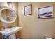 Charming powder room with a pedestal sink, decorative mirror, and beach-themed artwork at 1551 Victoria Ln., Myrtle Beach, SC 29577