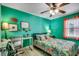 Cozy bedroom with colorful bedding, a ceiling fan, and a dedicated workspace at 1551 Victoria Ln., Myrtle Beach, SC 29577
