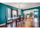 Elegant dining room featuring hardwood floors, decorative windows, modern chandelier, and access to kitchen at 1551 Victoria Ln., Myrtle Beach, SC 29577