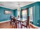 Stylish dining room showcasing hardwood floors, decorative windows, chandelier, and ample natural light at 1551 Victoria Ln., Myrtle Beach, SC 29577
