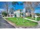 Charming two-story home with green siding, a screened-in porch, and a well-maintained lawn at 1551 Victoria Ln., Myrtle Beach, SC 29577