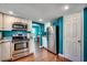 Bright kitchen featuring stainless steel appliances, white cabinets, and wood-look flooring at 1551 Victoria Ln., Myrtle Beach, SC 29577