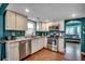 Well-lit kitchen with stainless steel appliances, granite countertops, and white cabinets at 1551 Victoria Ln., Myrtle Beach, SC 29577
