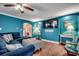 Inviting living space offers hardwood floors, teal walls, modern furnishings, and seamless access to laundry at 1551 Victoria Ln., Myrtle Beach, SC 29577