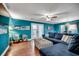 Bright living room features hardwood floors, teal walls, stylish furnishings, and abundant natural light at 1551 Victoria Ln., Myrtle Beach, SC 29577