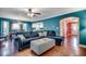 Comfortable living room boasts hardwood floors, teal walls, cozy seating, and an open layout to dining area at 1551 Victoria Ln., Myrtle Beach, SC 29577