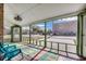 Bright screened porch with wood floors, fans, and views of neighborhood at 1551 Victoria Ln., Myrtle Beach, SC 29577