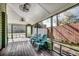 Relaxing screened porch with wooden floors, ceiling fans, and comfortable seating at 1551 Victoria Ln., Myrtle Beach, SC 29577