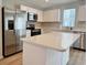 Well-equipped kitchen with stainless steel appliances, island, and white cabinets at 157 B Villa Grande St. # B, Myrtle Beach, SC 29579