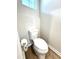 Compact powder room with a toilet, a roll of toilet paper, and neutral walls at 157 B Villa Grande St. # B, Myrtle Beach, SC 29579