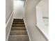Carpeted stairs with white railings offer access to the upper level of the home at 157 B Villa Grande St. # B, Myrtle Beach, SC 29579