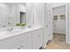 Bathroom featuring a double vanity with white marble countertops and a doorway leading to a closet at 158 Hoffman Park Dr. # 12, Myrtle Beach, SC 29588