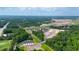 Expansive aerial view of new construction homes surrounded by lush greenery, pond, and community amenities at 166 Hoffman Park Dr. # 16, Myrtle Beach, SC 29588