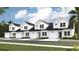 Newly built townhomes featuring white siding, black roofs and single car garages at 166 Hoffman Park Dr. # 16, Myrtle Beach, SC 29588