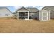 This beautiful backyard features a screened porch, a storage shed, and a well-maintained lawn at 1881 Moonseed Dr., Longs, SC 29568