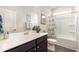 Bright bathroom with a modern vanity, framed mirror, and shower with a decorative curtain at 1881 Moonseed Dr., Longs, SC 29568