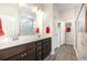 Bathroom featuring a double vanity, framed mirror, and a walk-in shower with marble tile and glass enclosure at 1881 Moonseed Dr., Longs, SC 29568