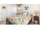 Comfortable bedroom featuring a wood-framed bed with tropical bedding and view of the closet at 1881 Moonseed Dr., Longs, SC 29568