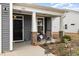 Inviting front porch with brick-based columns, seating area, and charming decor, creating a welcoming entrance at 1881 Moonseed Dr., Longs, SC 29568