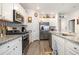 Modern kitchen featuring stainless steel appliances, granite countertops, white cabinetry and ample storage space at 1881 Moonseed Dr., Longs, SC 29568