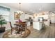 Open-concept kitchen and dining area with white cabinets, granite countertops, and stainless steel appliances at 1881 Moonseed Dr., Longs, SC 29568