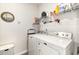 Efficient laundry room with a full-size washer and dryer and overhead storage shelving at 1881 Moonseed Dr., Longs, SC 29568